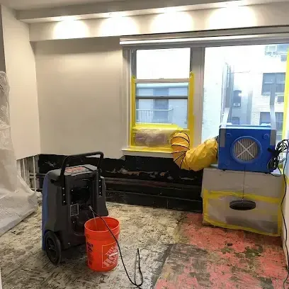 Dehumidifiers drying an older commercial building with a high ceiling