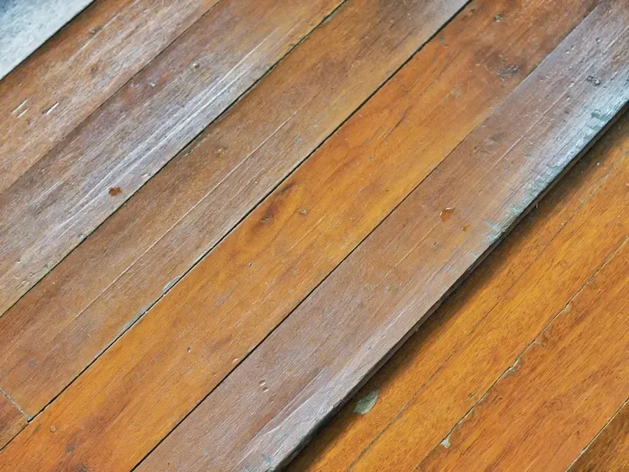 Oak floorboards cupped by water in an older house