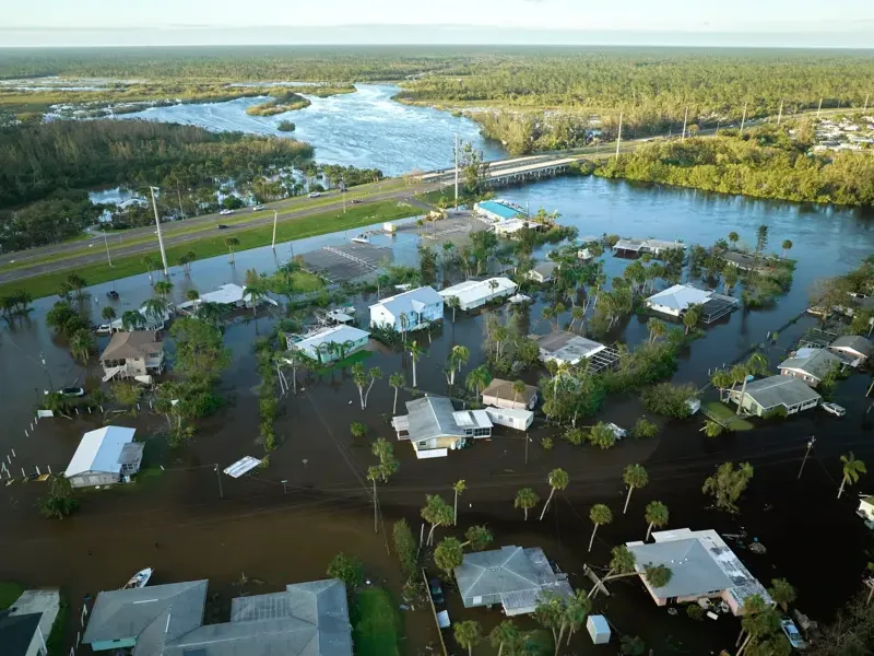 Storm runoff flooding a residential street after heavy rain